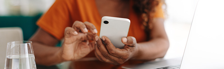 Close up photo of a woman looking at her phone Close up photo of a woman looking at her phone